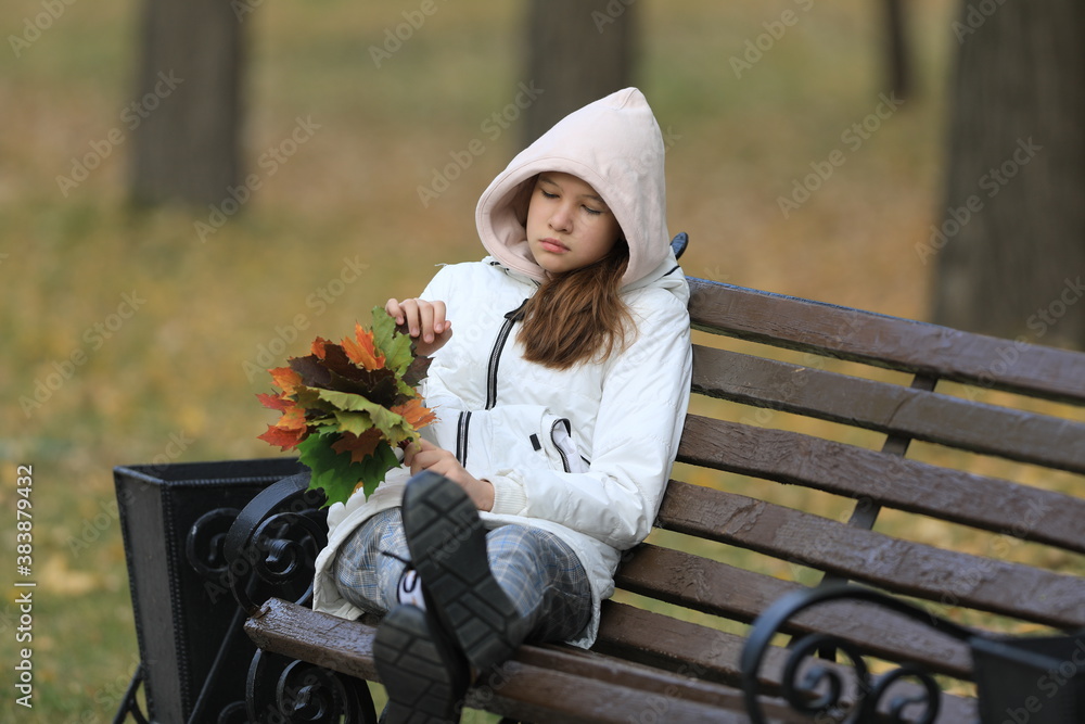 portrait of a young girl with autumn maple leaves portrait of a young girl with autumn maple leaves