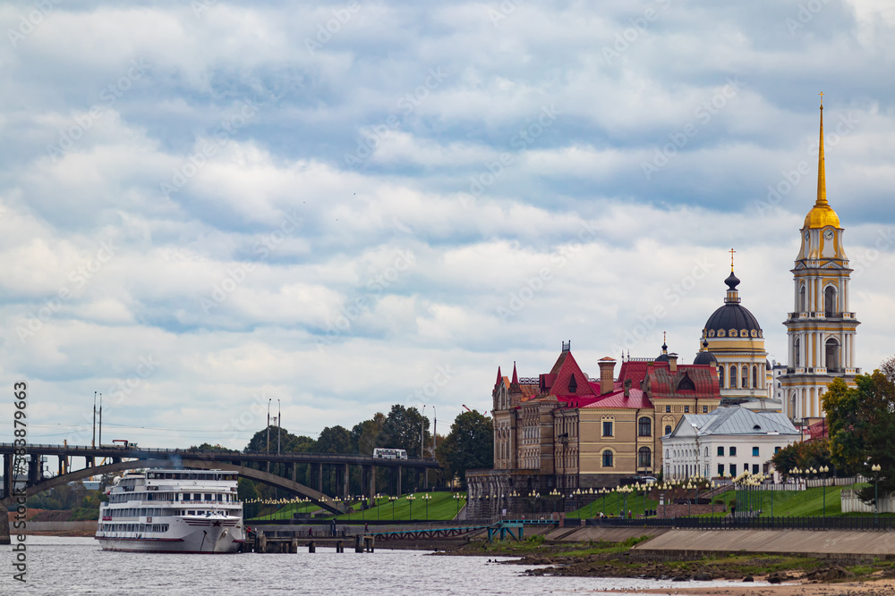A passenger ship is moored against the backdrop of a large Cathedral. Rybinsk, Russia.