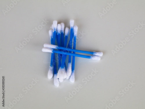 Blue color ear cleaning buds in packets against white background