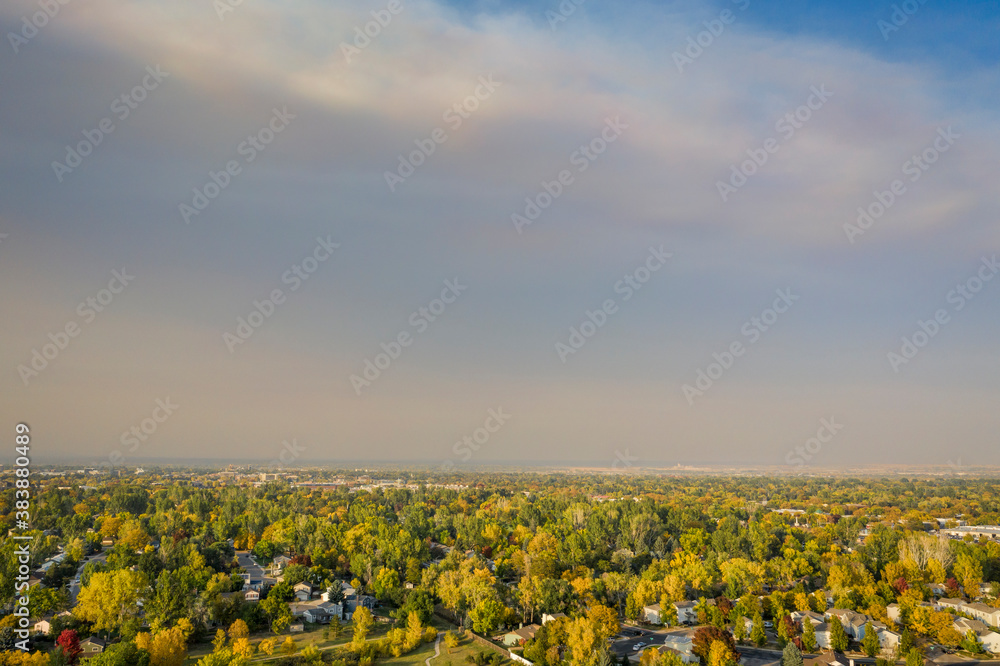 fall colors under wildfire smoke - aerial cityscape of Fort Collins in northern Colorado with smoke from Cameron Peak (CO) and Mullen (WY) Fires (October 2020), poor air quality with high PM2.5 index