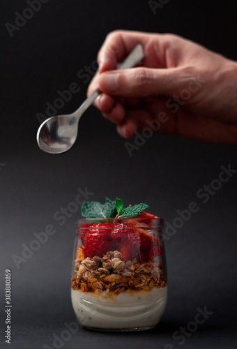 Yogurt with granola and strawberries on top