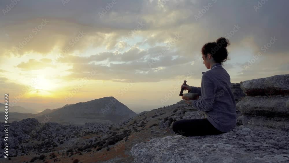 Relaxed woman practicing meditation in mountains Relaxed woman practicing meditation in mountains