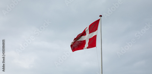 Danish flag with rain clouds in the background
