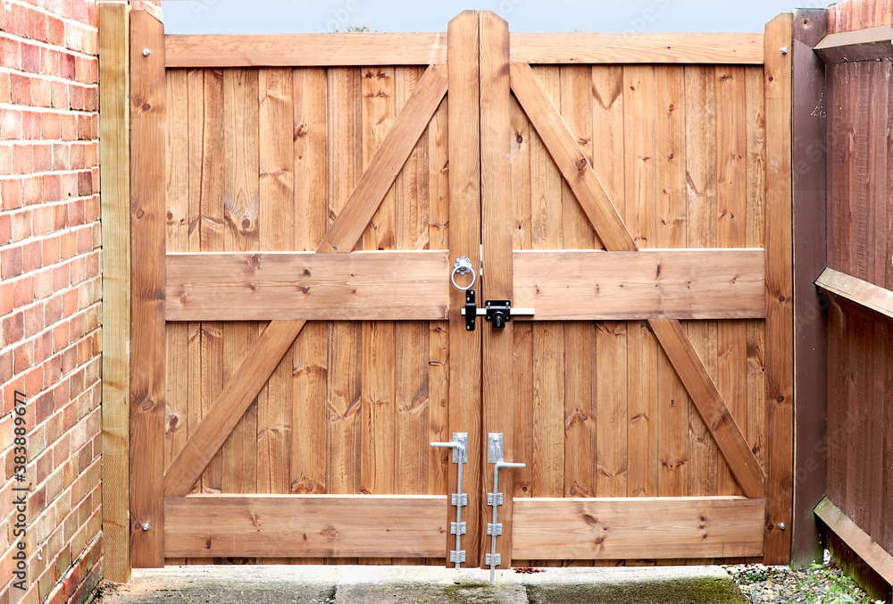 Double wooden gates with metal handle and lock bolt Double wooden gates with metal handle and lock bolt