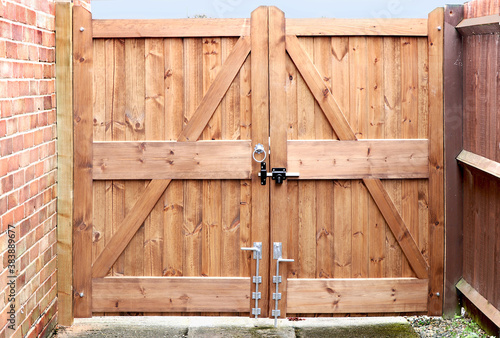 Fototapeta Double wooden gates with metal handle and lock bolt
