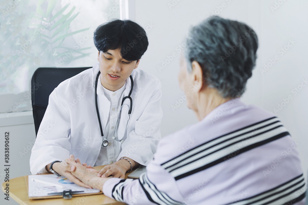 Young doctor examining elderly woman in hospital. Young doctor examining elderly woman in hospital.