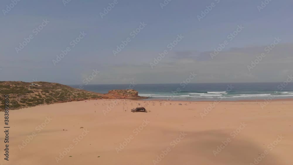 Beautiful Summer Scenery Of Sand Dune And Calm Blue Sea In A Touristic Beach In Carrapateira, Algarve, Portugal - aerial drone Beautiful Summer Scenery Of Sand Dune And Calm Blue Sea In A Touristic Beach In Carrapateira, Algarve, Portugal - aerial drone