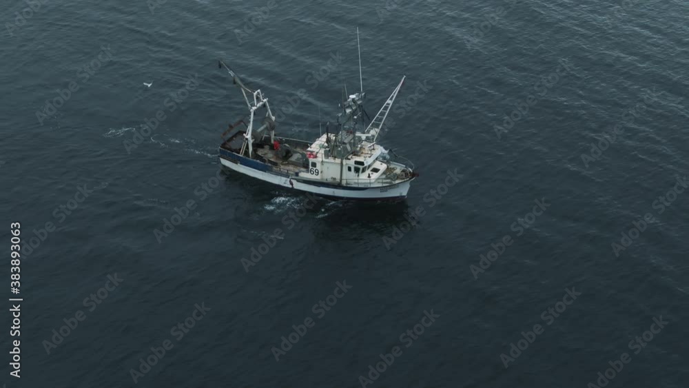 Fisherman On Fishing Trawler Sailing On The Calm Open Waters Of Saint Lawrence River In Quebec, Canada. - aerial Fisherman On Fishing Trawler Sailing On The Calm Open Waters Of Saint Lawrence River In Quebec, Canada. - aerial