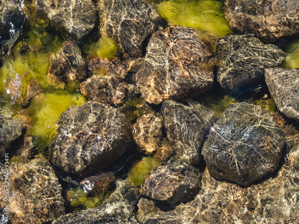 Overhead view of stones under the surface of a lake Overhead view of stones under the surface of a lake