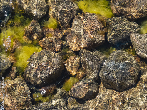 Overhead view of stones under the surface of a lake