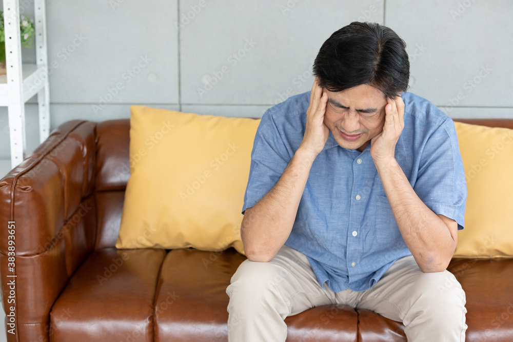 senior asian man suffering from headache at home senior asian man suffering from headache at home