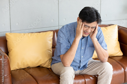 senior asian man suffering from headache at home © offsuperphoto