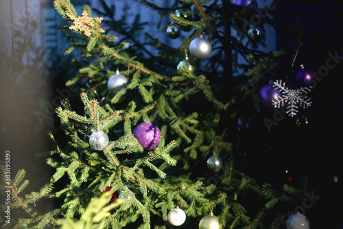 Colorful ornaments on a Christmas tree in the garden. Selective focus.