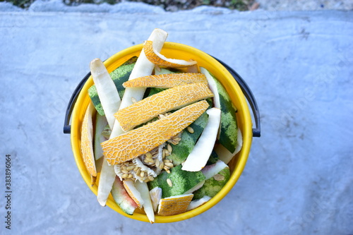 Yellow and white bucket with food waste of vegetables and fruits