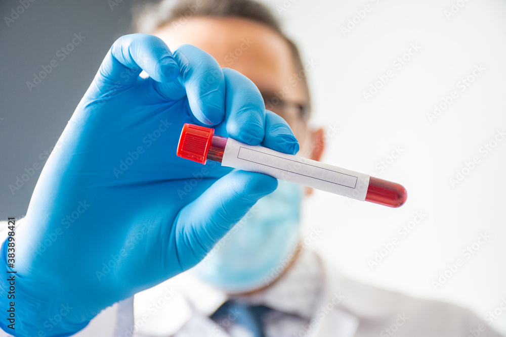 The doctor or laboratory assistant holds in his hand a laboratory tube with blood and a clean place to enter the text of the analysis that will be carried out. Concept photo for diagnostics of hormone The doctor or laboratory assistant holds in his hand a laboratory tube with blood and a clean place to enter the text of the analysis that will be carried out. Concept photo for diagnostics of hormone