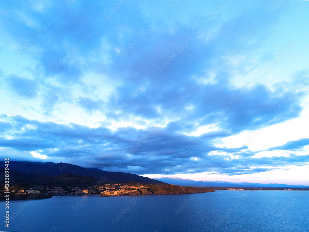 Collioure bay viewed from air above the sea at sunrise