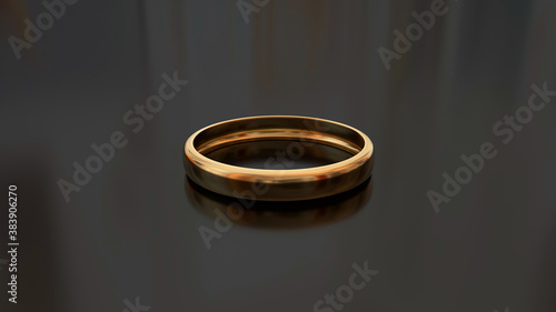 Golden ring on a glass table.