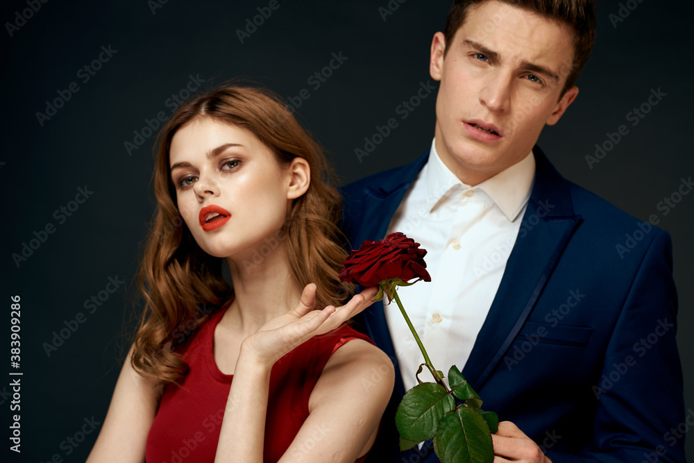 young couple hugs charm red rose relationship black background