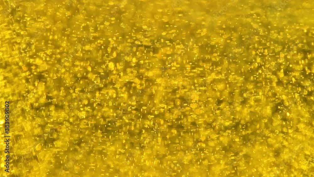 Golden blinking particles liquid motion background,beer bubbles flowing,slow motion Golden blinking particles liquid motion background,beer bubbles flowing,slow motion