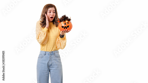 Portrait of Asian woman surprised face and looked at the pumpkin Halloween concept.