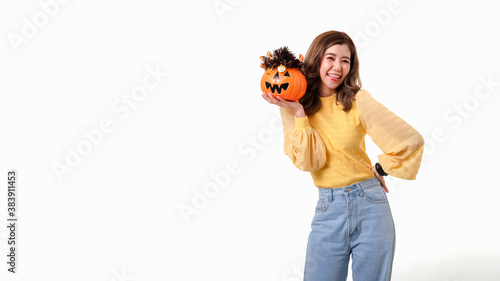 Portrait of Asian smiling woman holding curved pumpkin and looking at camera isolated over white background Halloween concept.