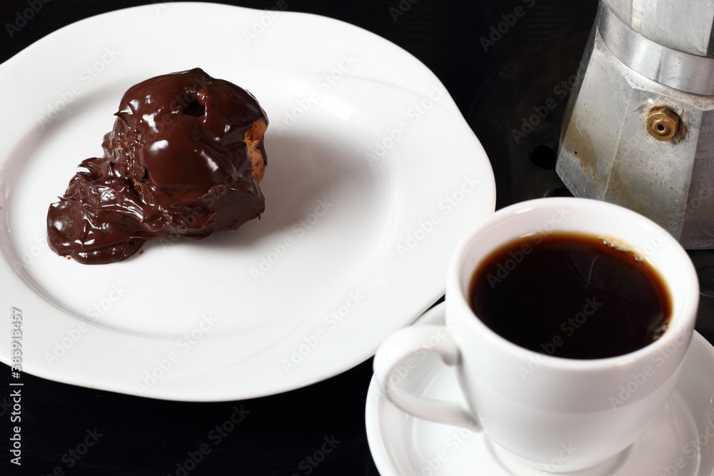 Coffee cup and single cream puff Coffee cup and single cream puff