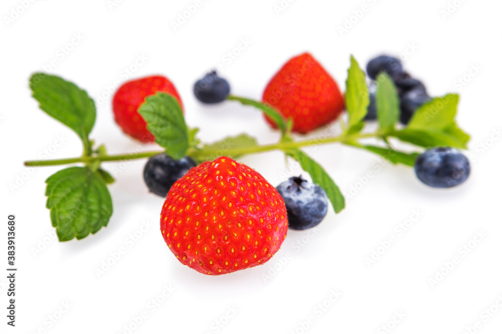 Strawberries and blueberries with mint leaves on a white background Strawberries and blueberries with mint leaves on a white background