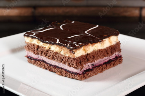 Layer cake with fruit and cream fillings decorated chocolate icing