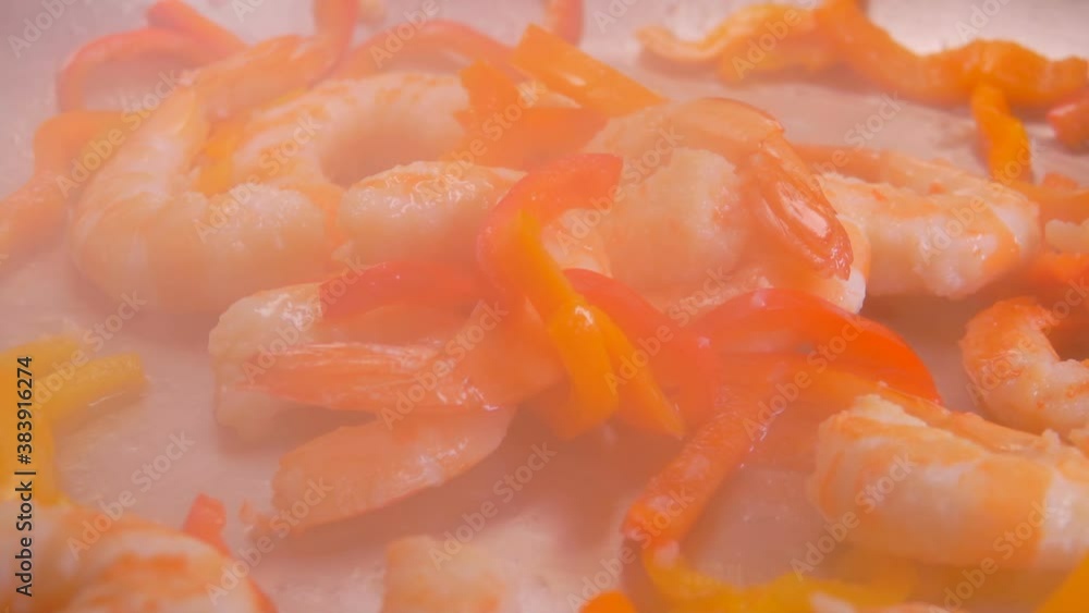 Roundabout close-up panorama of the delicious large shrimps and paprika frying on the pan Roundabout close-up panorama of the delicious large shrimps and paprika frying on the pan