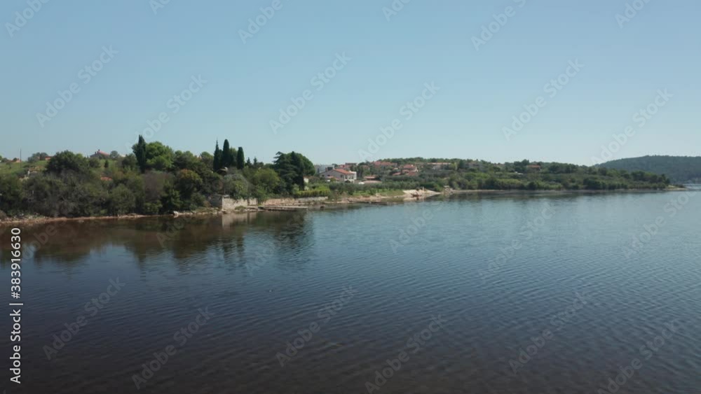 Aerial shot of a lagoon near Pula, Croatia. Camera tracks to the right. Small town in the background. Aerial shot of a lagoon near Pula, Croatia. Camera tracks to the right. Small town in the background.