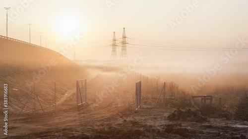 Industrial landscape at foggy dawn