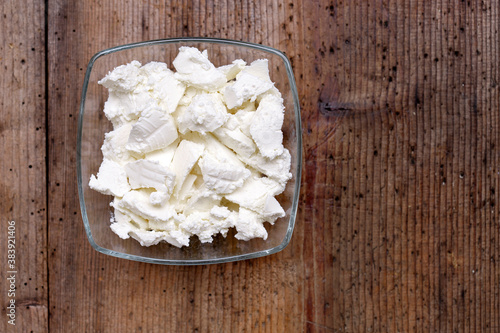 Ricotta cheese on wood background