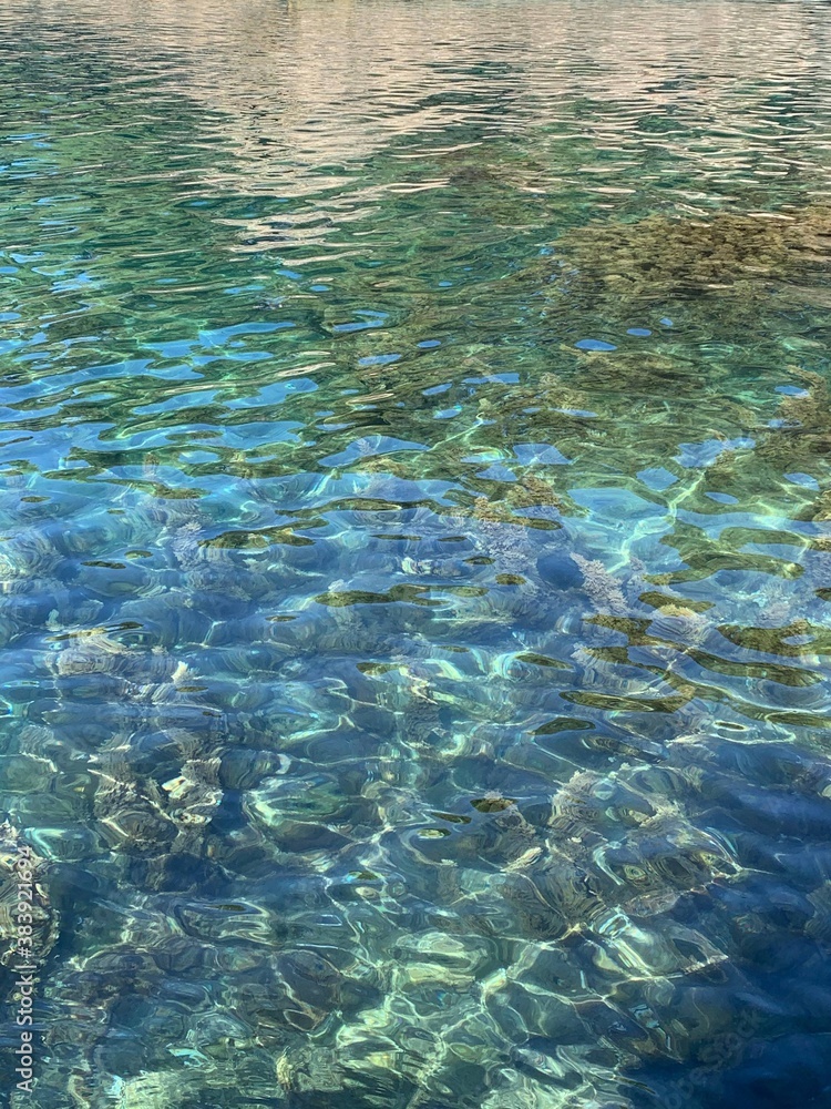 Turquoise crystal clear calm rippled Adriatic sea water surface, pebble seabed with seaweed algae, relax, meditation, tranquility in summer season. Turquoise crystal clear calm rippled Adriatic sea water surface, pebble seabed with seaweed algae, relax, meditation, tranquility in summer season.