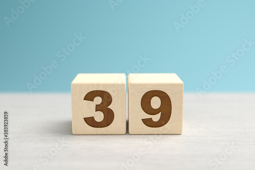 Wooden toy blocks forming the number 39.