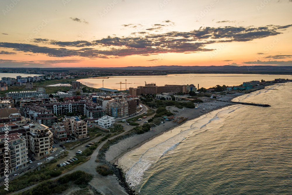 Aerial view of Pomorie city that is located on Black Sea shore. Top view of sand beaches with many hotel buildings and tourist infrastructure.