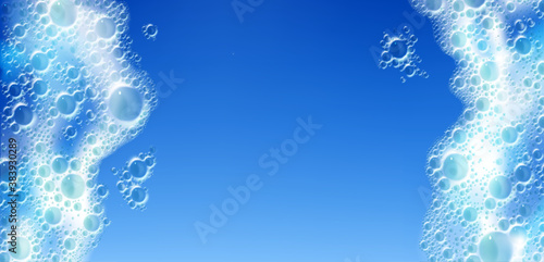 Soap foam texture isolated on blue background. Vector realistic illustration of soap sud of detergent, cleaning gel or shampoo. White froth with bubbles in laundry, bath or shower