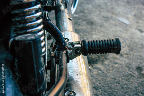 Fototapeta Naklejka Na Ścianę i Meble -  Closeup of a motorcycle parked in the streets of the city center of the metropolitan area
