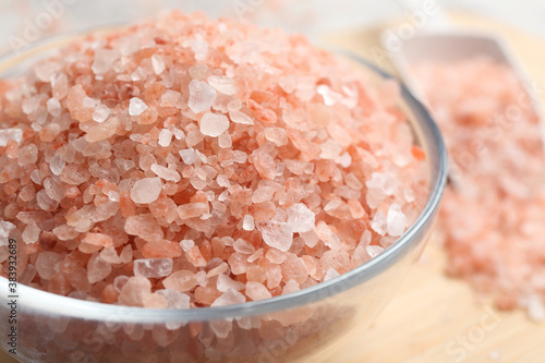 Pink himalayan salt in glass bowl on table, closeup