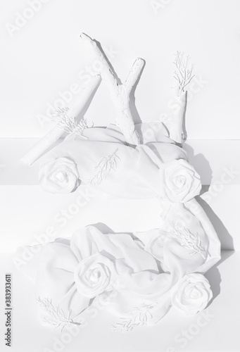 Fashion still life winter scene. Roses, brunch and textile decor. Minimal stylish white colours design