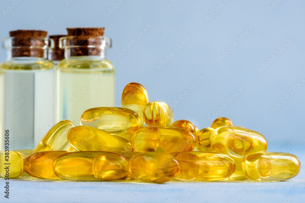 Health, vitamins and natural medicines - omega 3 capsules on a blue background. Health, vitamins and natural medicines - omega 3 capsules on a blue background.