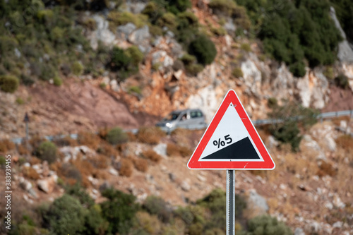 Road sign informing about steep rise on the mountain serpentine road