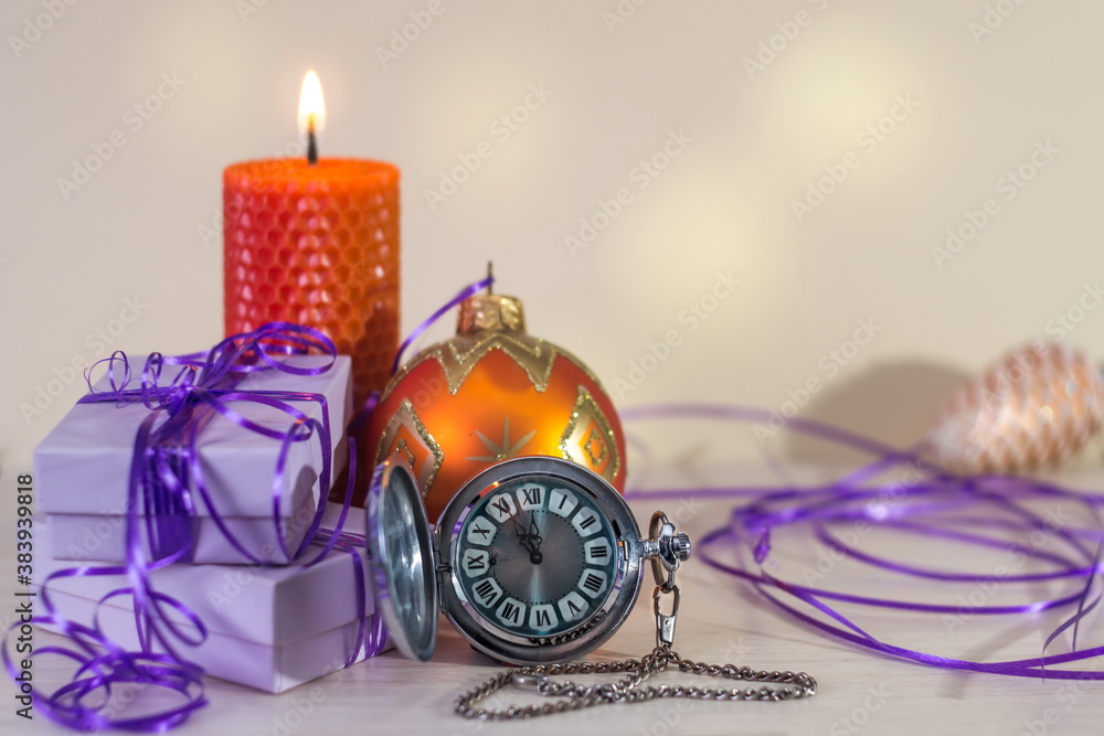 christmas and new year postcard with candle, gifts, Christmas decorations and retro watch christmas and new year postcard with candle, gifts, Christmas decorations and retro watch
