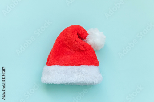 Simply minimal design Christmas Santa Claus hat isolated on blue pastel colorful trendy background