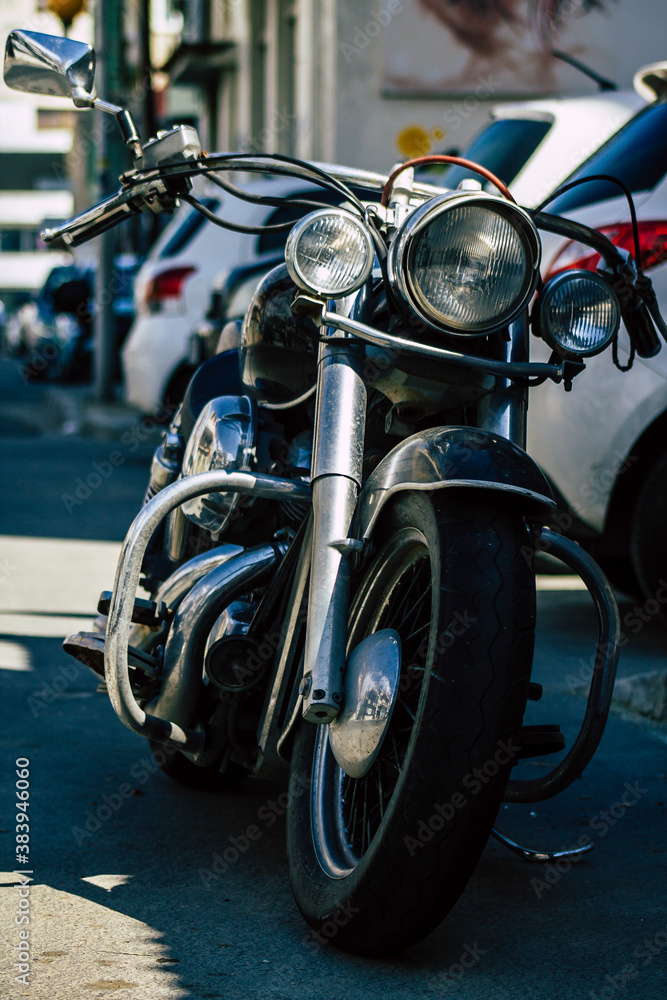 Fototapeta Closeup of a motorcycle parked in the streets of the city center of the metropolitan area