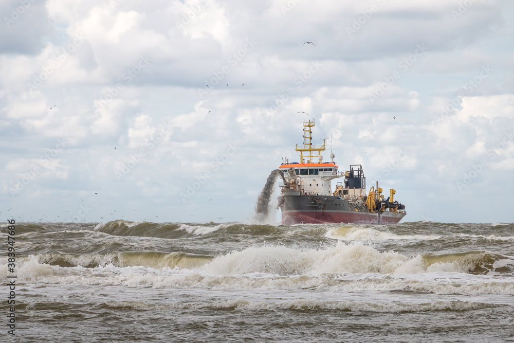 Dredger on the North Sea coast in the Netherlands, province of North Holland Dredger on the North Sea coast in the Netherlands, province of North Holland