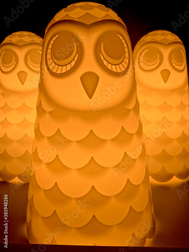 Orange golden table lamps aligned in a scary army of owls or ghosts amazing Halloween or Christmas theme colored lights fancy and creative way to decorate home