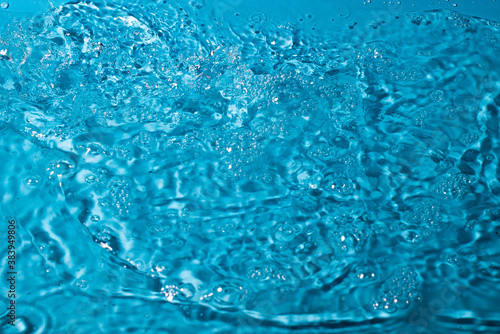 splash of water on a blue background. Abstract wallpaper