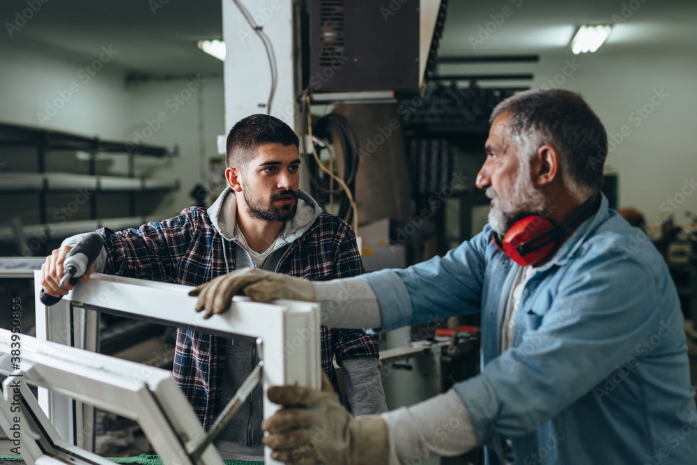 Aluminium and PVC industry workers making PVC frames for windows Aluminium and PVC industry workers making PVC frames for windows