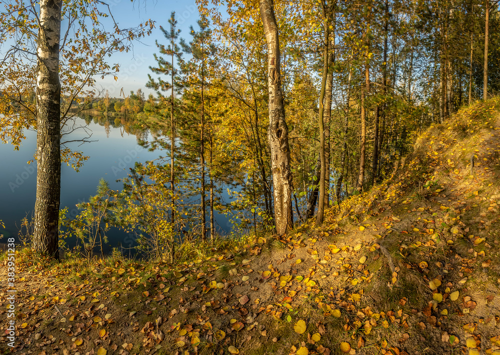 Fototapeta premium Beautiful autumn evening on the bank of the quarry.