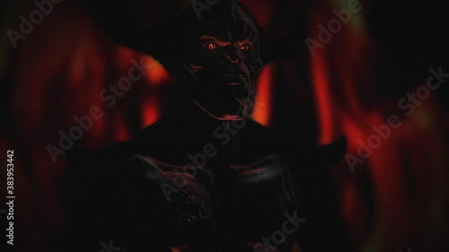 Animation of the appearance of a devil from the darkness or fire. Horror or religion scene.